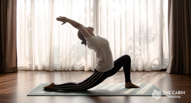 A woman practicing yoga for the benefits of holistic addiction treatment for young adults.